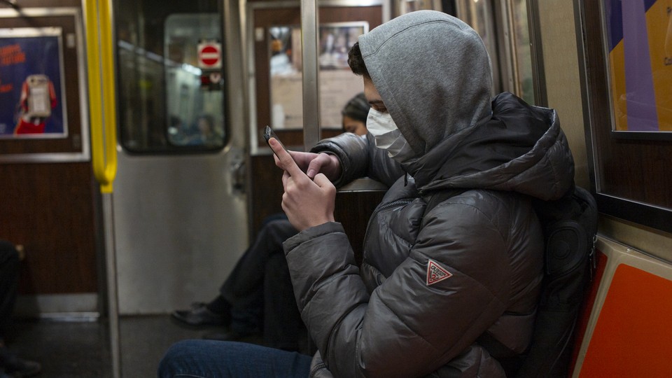 A man wearing a face mask on the subway