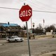 a street in a state of abandonment and disrepair with an upside down Stop sign