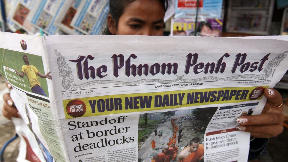 A woman reads The Phnom Penh Post in Cambodia