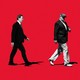 Illustration of Ross Perot walking toward Pat Buchanan walking toward Donald Trump on a red background