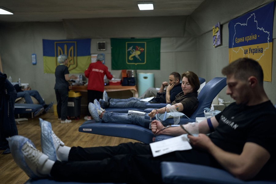 Several people sit in comfortable seats while donating blood.