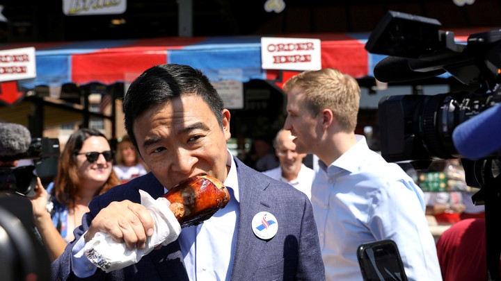 Andrew Yang enjoying a turkey leg at the Iowa State Fair