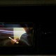 Trump through a car window using his phone
