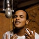 A young Harry Belafonte singing into a microphone