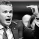 Pete Hegseth speaking in a grid of black-and-white images on a red background