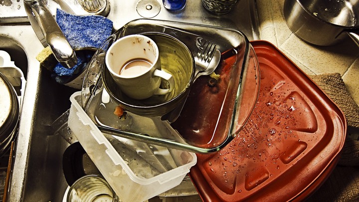 A pile of dirty dishes in a sink