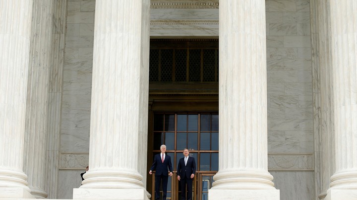 Justice Neil Gorsuch and Chief Justice John Roberts stand on the U.S. Supreme Court building steps in June.