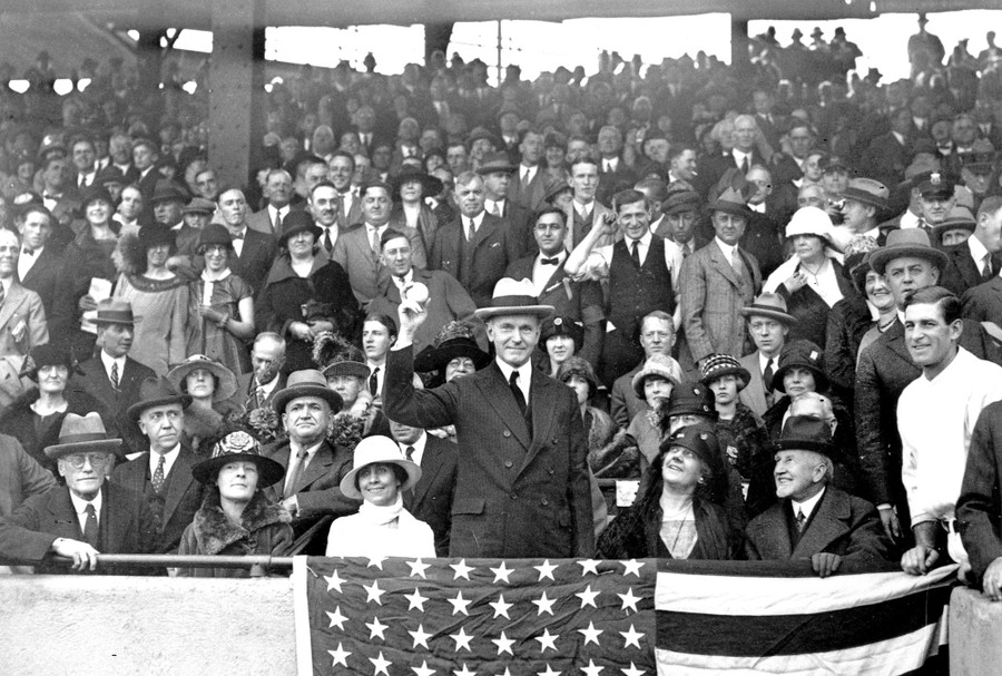 President Calvin Coolidge, in a large crowd, throws out the ball for the opening game of the 1924 World Series.