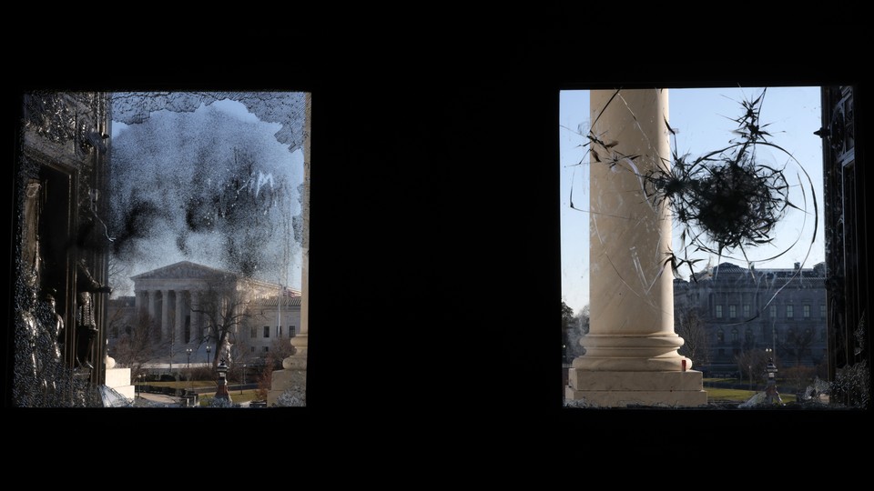 Windows at the Capitol pocked with bullet holes