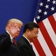 Donald Trump and Xi Jinping are positioned in front of an American flag.