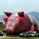 A giant sculpture of a pig with red eyes