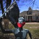 A statue of Olympic marathon gold medalist Joan Benoit Samuelson wears a red bandana mask outside the library in Cape Elizabeth, Maine