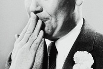 Black-and-white photo of a person holding their hand to their mouth