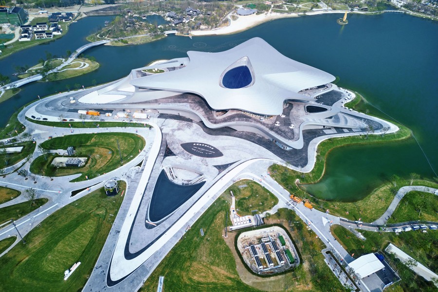 An aerial view of a large museum, with swooping rooflines and shapes across its grounds.