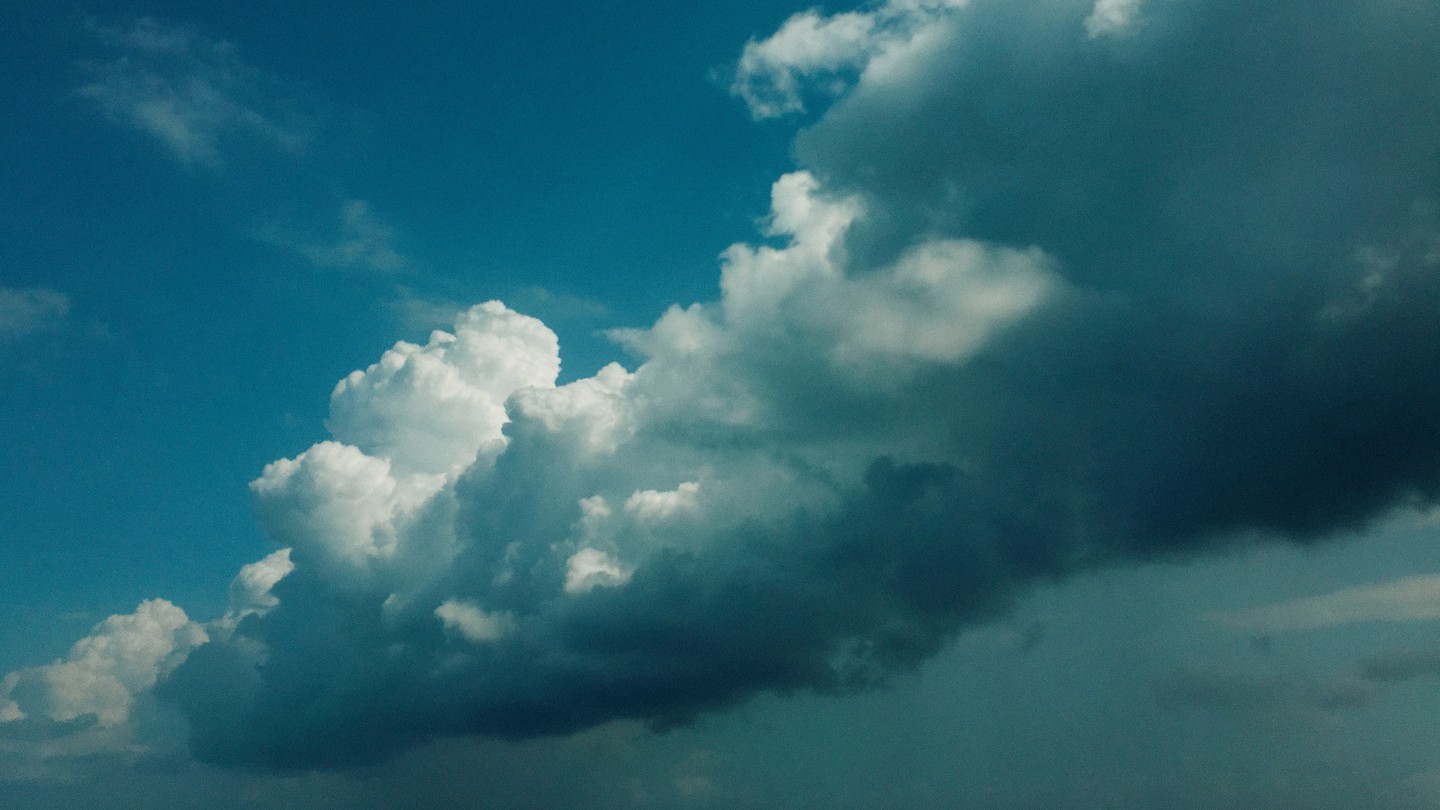 A photo of blue-tinted clouds in a blue sky