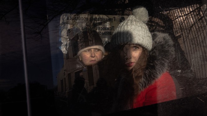 Two women look out of a car window