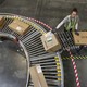 A worker loads Amazon packages onto a conveyor belt.