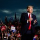 Donald Trump at a rally in Florida, with dark clouds in the background