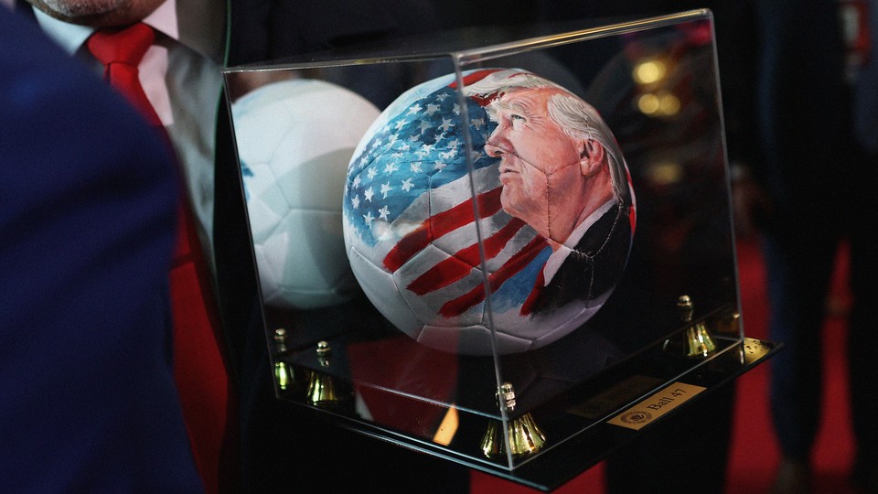 An image of a soccer ball painted with President Trump’s face and an American flag on it in a glass case titled “Ball 47”