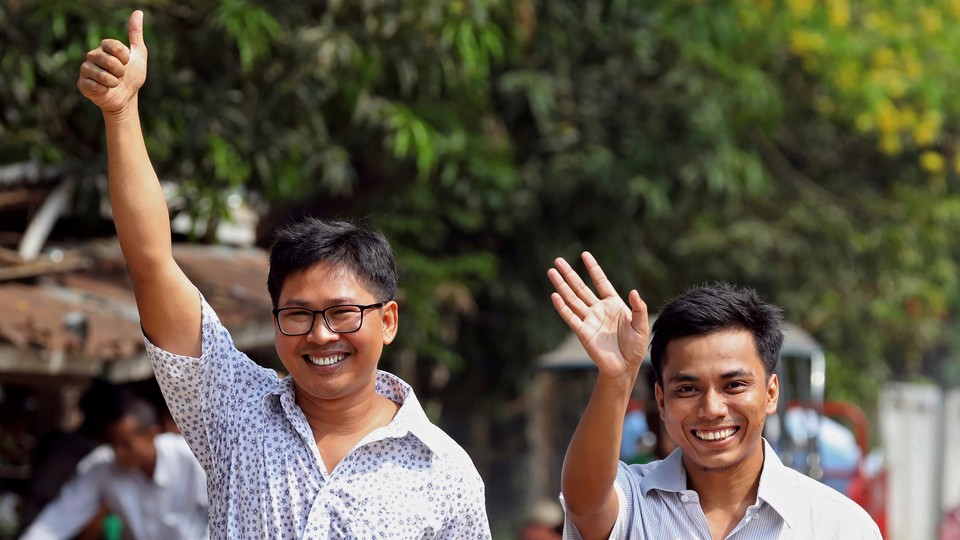 Reuters reporters Wa Lone and Kyaw Soe Oo walk to Insein prison gate after being freed.