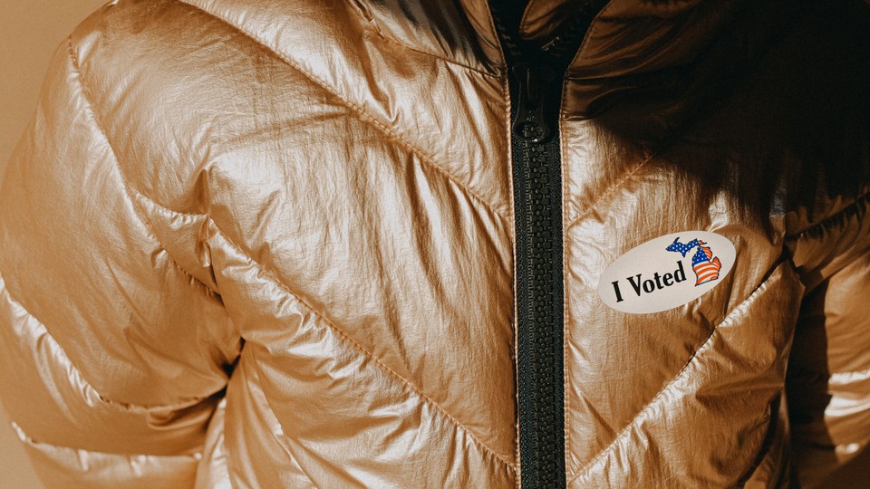 An "I Voted" sticker on a golden puffer jacket