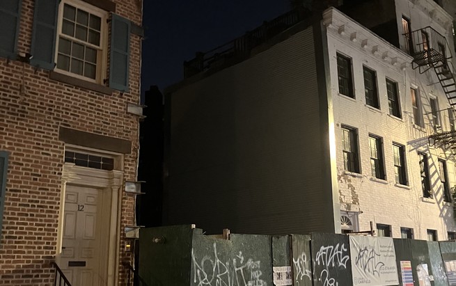 12 Gay Street, a brick house, next to a vacant lot, where a house was torn down.