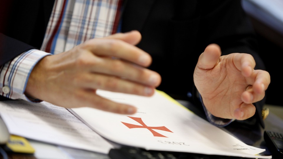 The Flemish right-wing party member Tanguy Veys holds his hands over a copy of Anders Behring Breivik's manifesto.