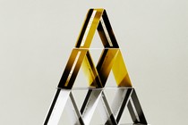 A pyramid of stacked credit cards, with gold ones at the top