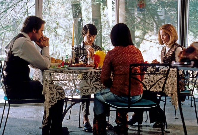 A family of four seated at a dinner table