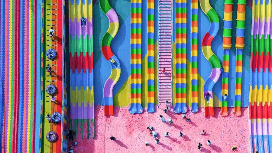 An aerial view of bright, multicolored slides on a playground