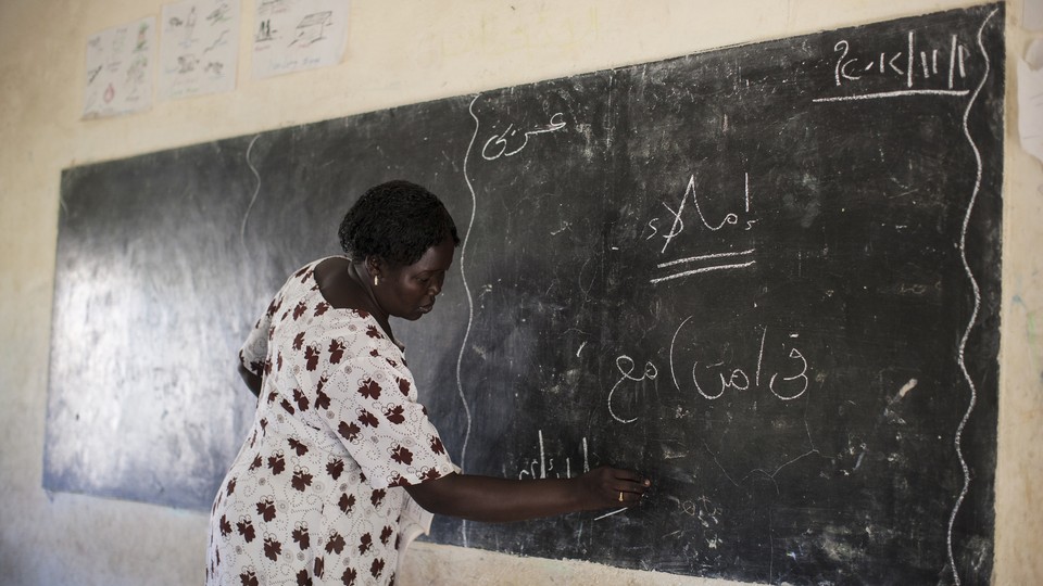 A mathematics teacher writes on the chalkboard at the Juba One Girls Basic Education School, in South Sudan, in 2012.