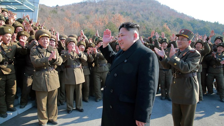 North Korean leader Kim Jong Un waving to North Korean officers during the launch of ballistic missiles
