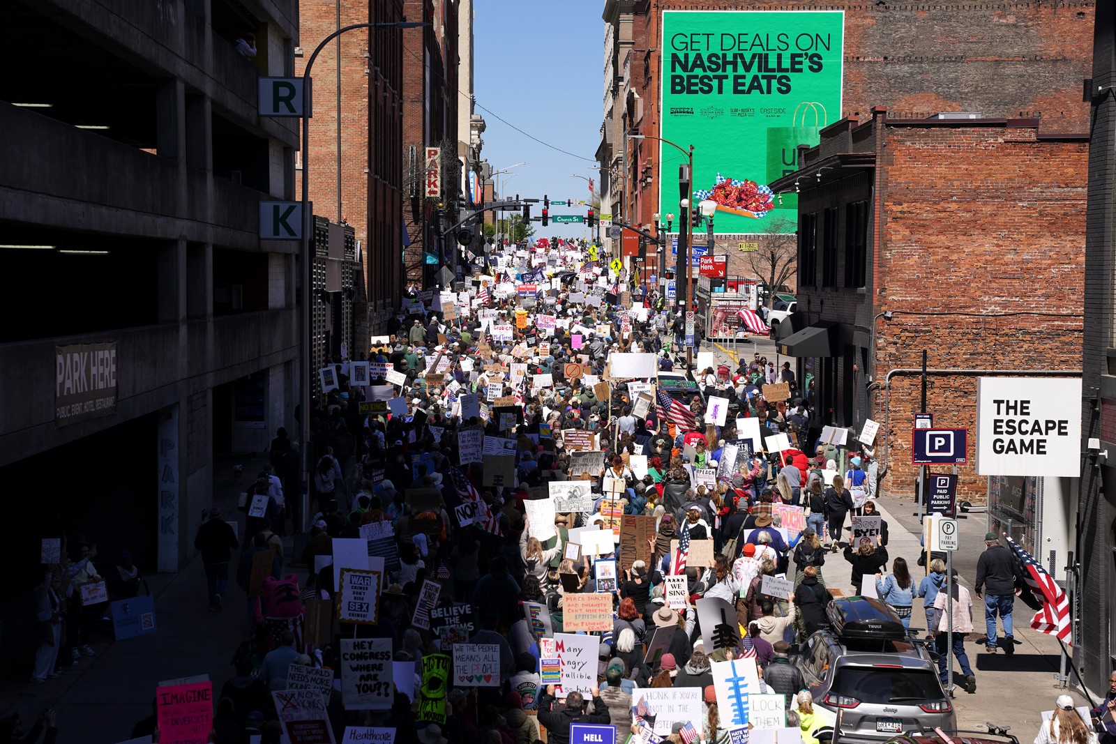 Thousands of protesters marched down a street in downtown Nashville.