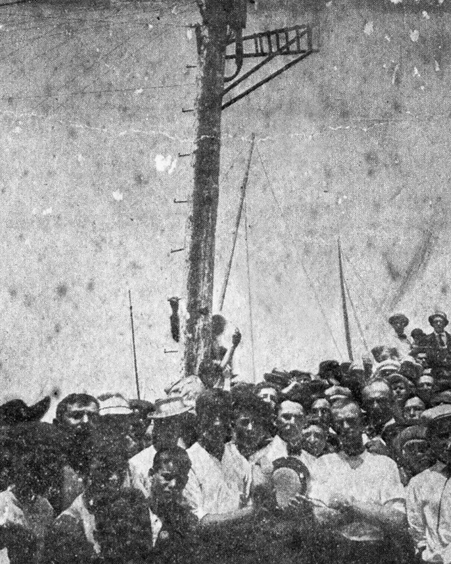 The lynching of James Reed, in Crisfield, Maryland, on July 28, 1907, for the alleged murder of the police officer John H. Daugherty. This image was modified for The Atlantic by the artist Ken Gonzales-Day, whose technique, as showcased in his "Erased Lynchings" project, is to digitally remove the victim and rope from historical photographs of lynchings. By erasing the victims’ bodies, Gonzales-Day pushes the viewer to focus on the crowd and, by proxy, the racism and bias that were foundational to these acts of violence.