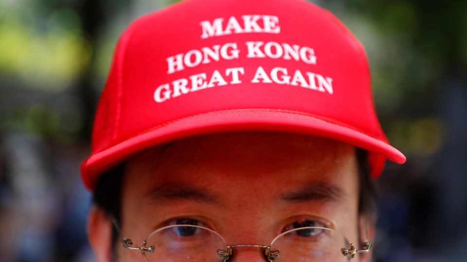 Photo of protestor in Hong Kong wearing Make Hong Kong Great Again hat