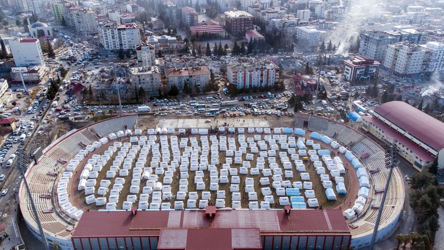 An aerial view of dozens of tents erected inside a sports stadium