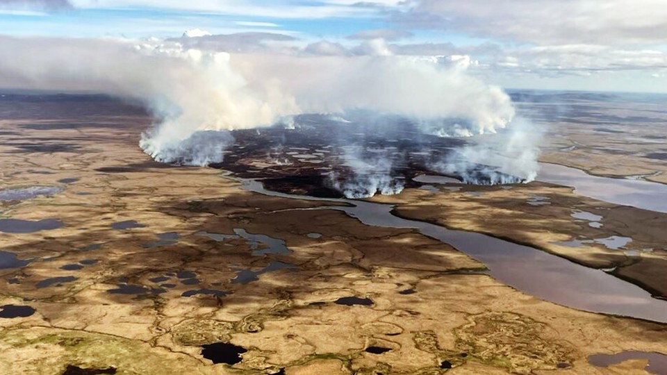 An aerial shot of a fire burning in Alaskan tundra