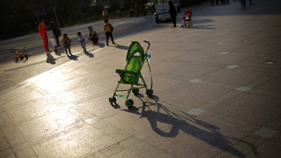 An empty baby stroller is seen in downtown Shanghai, in 2013.