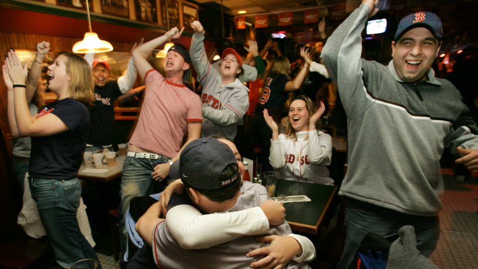 Boston baseball fans cheer while watching a Yankees–Red Sox game in 2004.