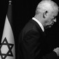Benny Gantz in profile next to an Israeli flag