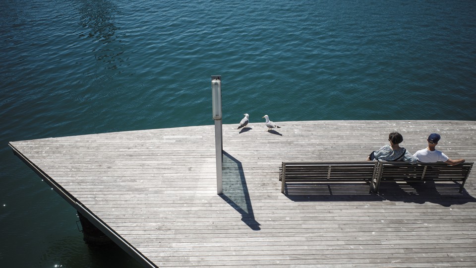 Two people looking at ocean
