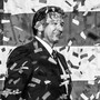 A black-and-white photo of Ron DeSantis amid falling confetti