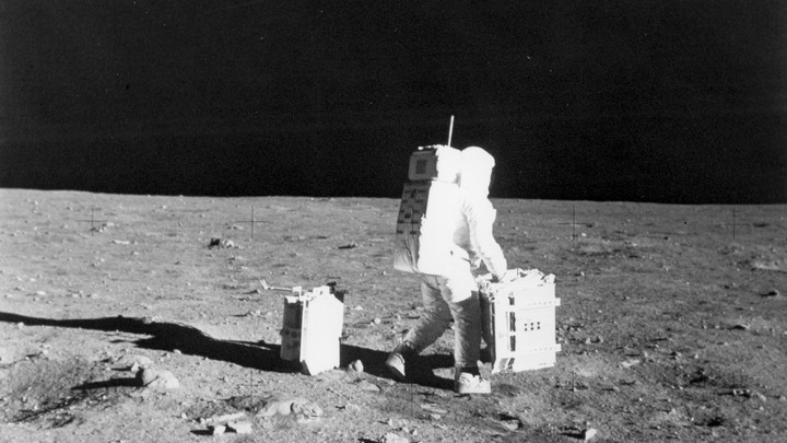 Buzz Aldrin moves equipment on the moon.