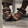 A detainee's feet are shackled to the floor as he attends a "Life Skills" class inside the Camp 6 high-security detention facility at Guantanamo Bay U.S. Naval Base in 2010.