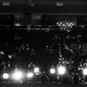 Attendees at the 2024 Republican National Convention sit in the audience, behind a row of bright lights and a banner reading "Make America great"