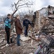 Residents stand outside a building on the outskirts of Chernihiv