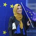 A Muslim woman holds a European flag during a pro-EU demonstration.