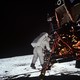 Astronaut Buzz Aldrin steps off the ladder from the lunar module and onto the moon.