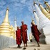 Buddhist monks walk through the Shwe Indein Pagoda near Inle lake in Myanmar.