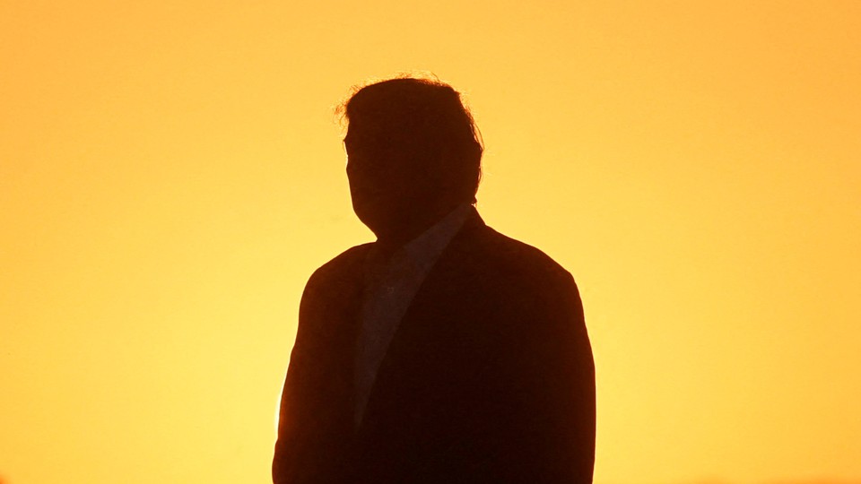 A photo of Trump's silhouette against a yellow background